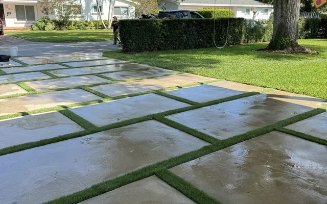 Modern paver and turf strip driveway with green turf ribbons installed by Govorex