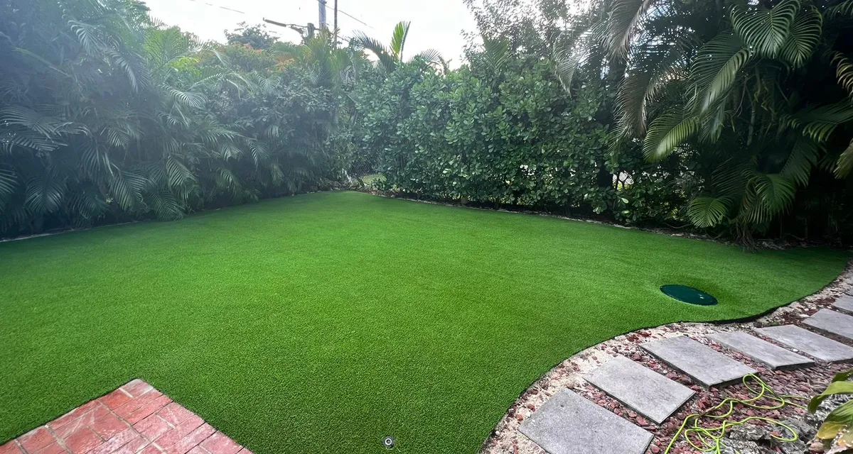 Established artificial grass lawn holding its color in full sun