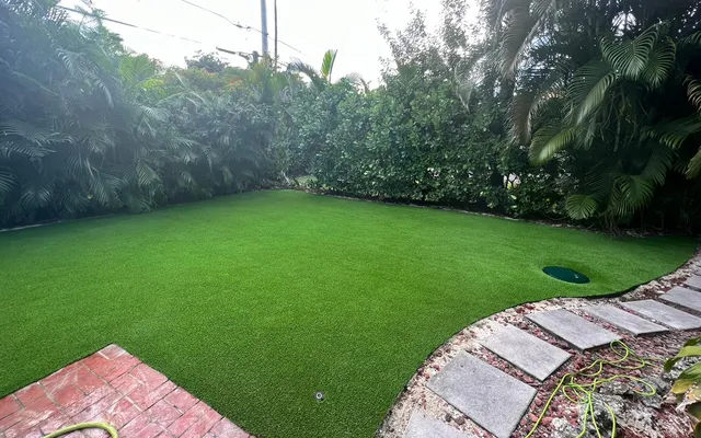 Established artificial grass lawn holding its color in full sun
