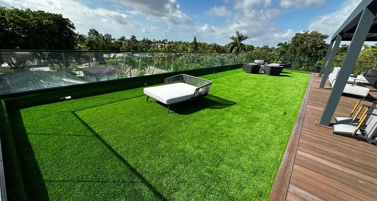 Shaded backyard with mature tree canopy finished in thick artificial turf