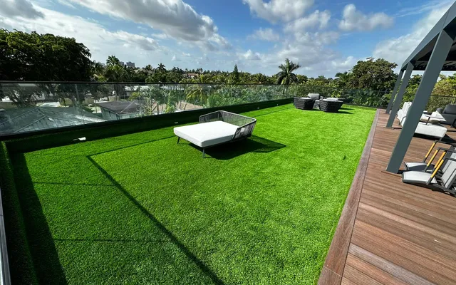 Shaded backyard with mature tree canopy finished in thick artificial turf