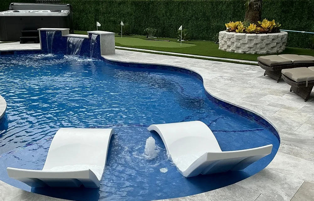 Artificial turf lawn beside a pool deck with no standing water or bare, muddy patches