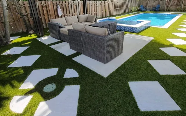 Evenly colored artificial turf lawn with crisp edges along a garden bed